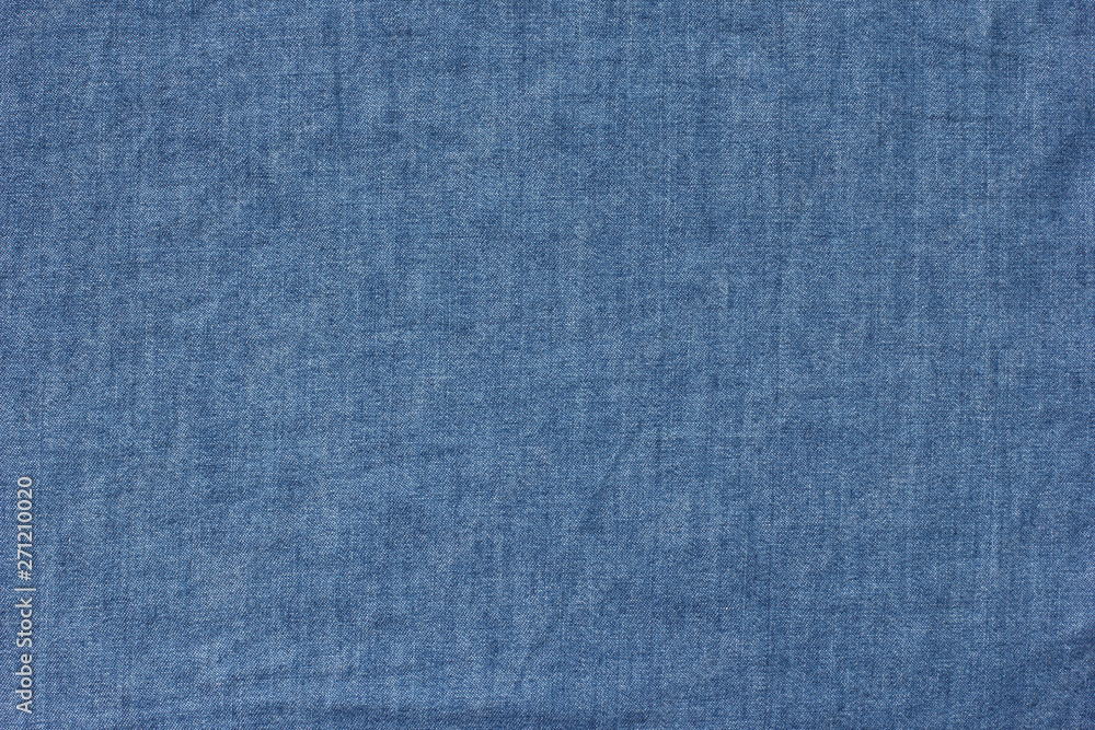 Old blue denim jeans texture or background with visible fibers Old blue denim jeans texture or background with visible fibers