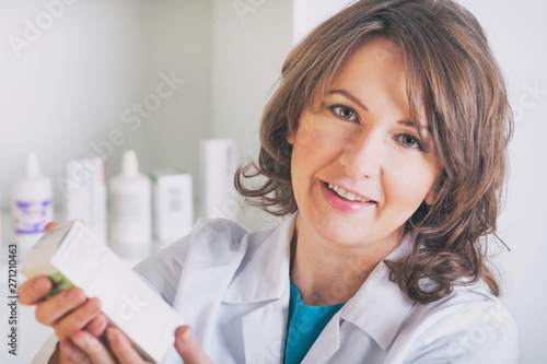 Pharmacist showing a medicine in the drugstore
