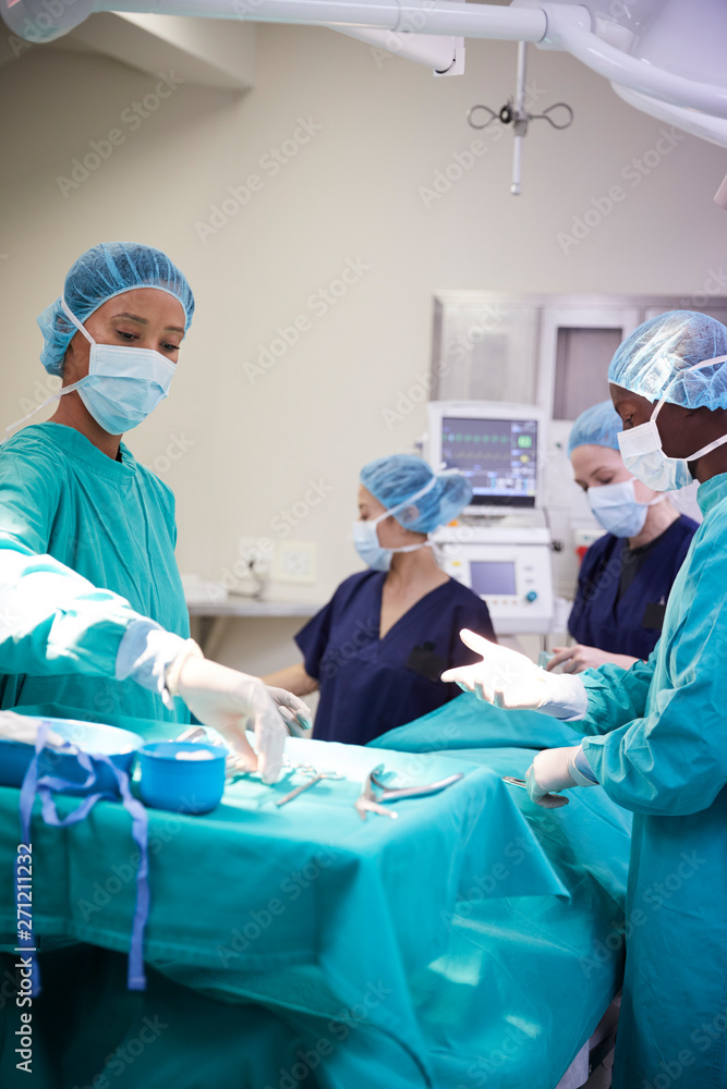 Surgical Team Working On Patient In Hospital Operating Theatre Surgical Team Working On Patient In Hospital Operating Theatre