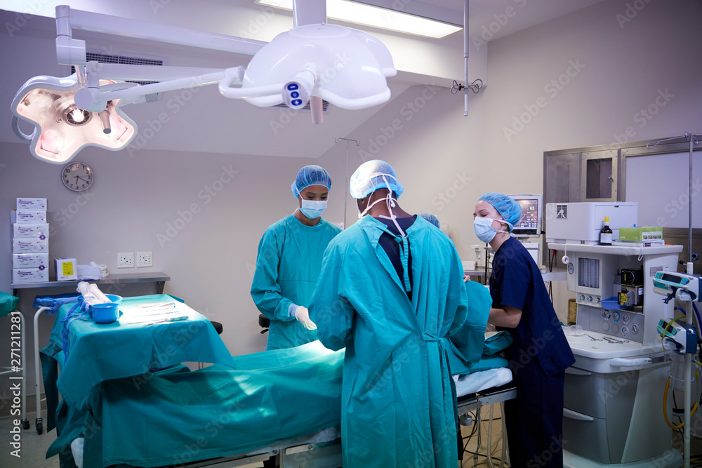 Surgical Team Working On Patient In Hospital Operating Theatre Surgical Team Working On Patient In Hospital Operating Theatre