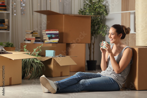 Happy tenant resting drinking coffee moving home photo