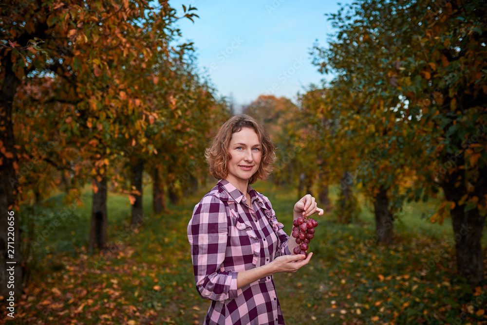 woman with grapes in the garden woman with grapes in the garden