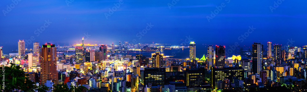Panoramic aerial view of downtown in Kobe, Japan at night. Blue sky
