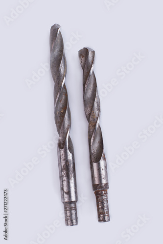 Old drill bits, top view. Used metal tools isolated on white background.