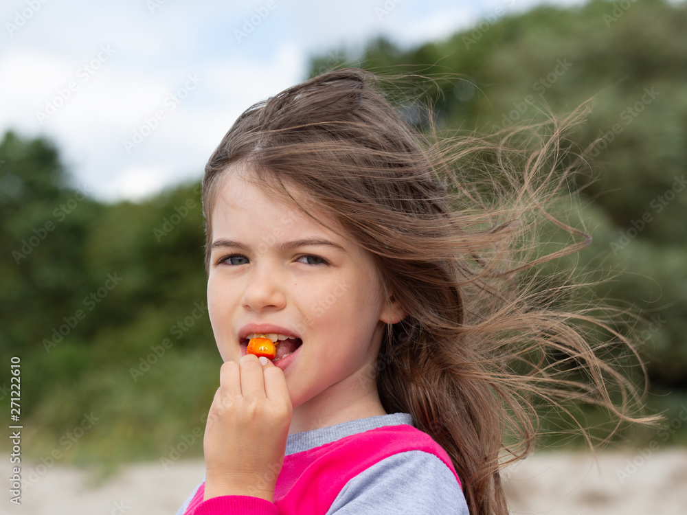 little cute girl eating rosehip little cute girl eating rosehip
