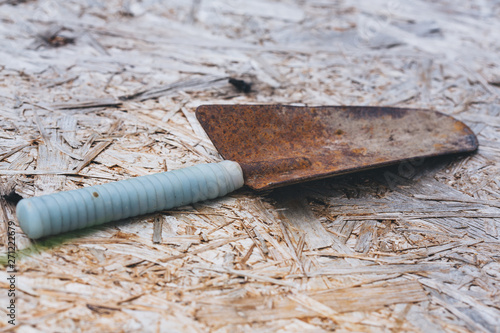  old rusty garden shovel on wooden background