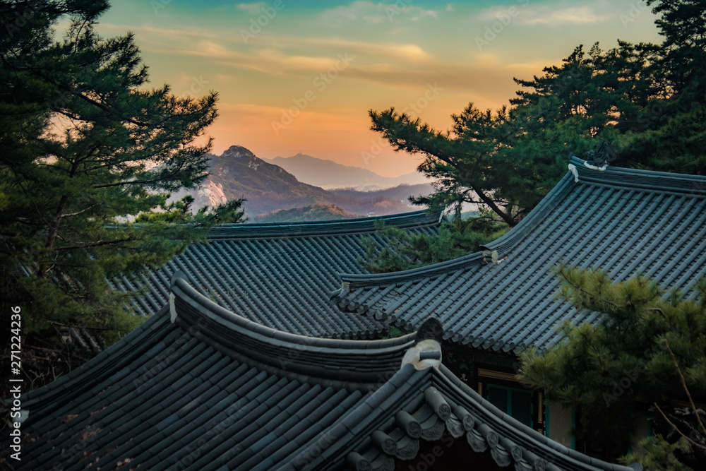 View of moutains and temple roof at sunset in Geumsunsa temple near Seoul, Korea