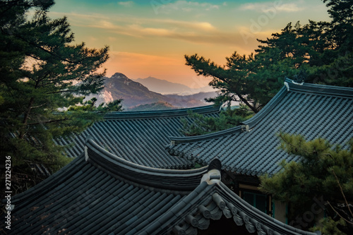 View of moutains and temple roof at sunset in Geumsunsa temple near Seoul, Korea © Yann