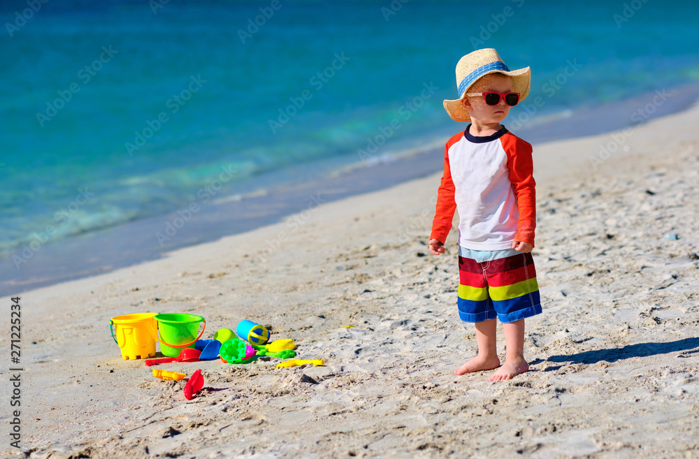 Two year old toddler playing on beach Two year old toddler playing on beach