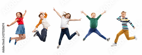 Fotografie childhood, fun and motion concept - happy children jumping over white background
