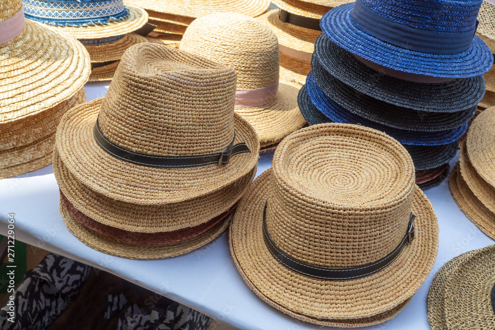 Straw hats for sale, for men and women of light colors.