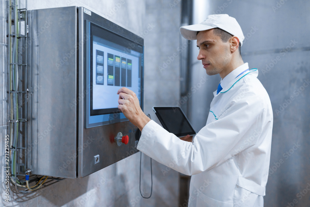 man in a white robe and a cap make a configure the digital screen man in a white robe and a cap make a configure the digital screen