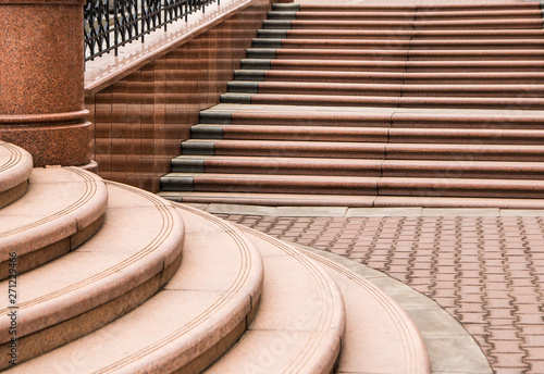 Elements of city architecture. Steps from red granite and red stone blocks. 