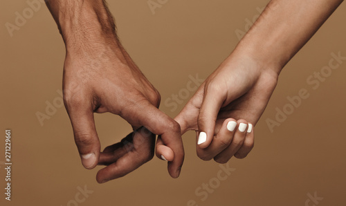 Couple linking index fingers photo