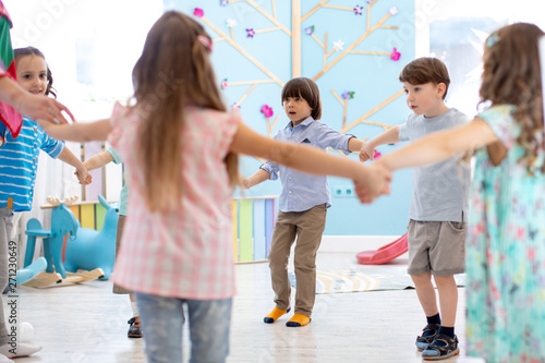 Little children roundelay on lesson in kindergarten