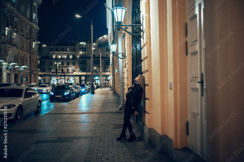 beauty woman posing over night illuminated street