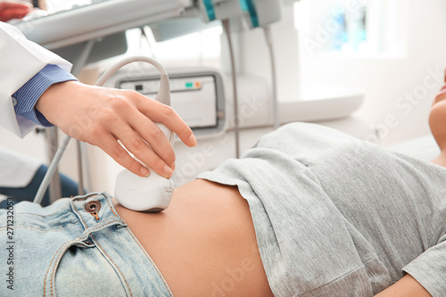 Woman undergoing ultrasound scan in clinic photo