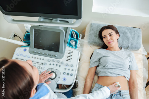 Woman undergoing ultrasound scan in clinic photo