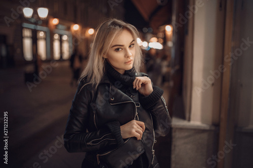 beauty woman posing over night illuminated street