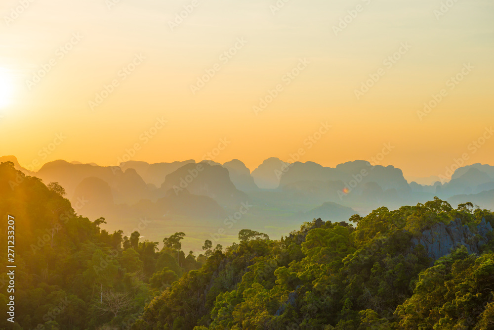 Beautiful landscape with dramatic sunset, tropical rainforest and steep mountain ridge on horizon. Krabi, Thailand - obrazy, fototapety, plakaty 