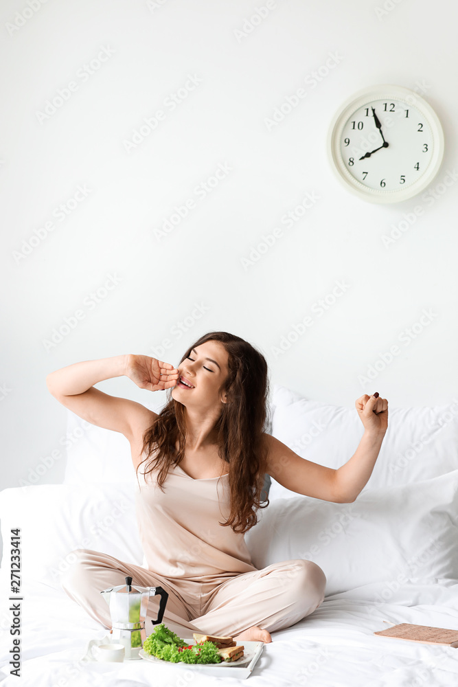 Beautiful young woman having breakfast in bed Beautiful young woman having breakfast in bed
