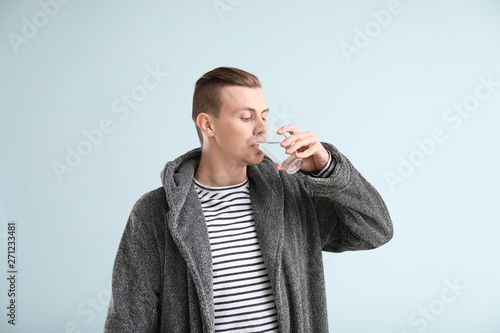 Handsome young man drinking...