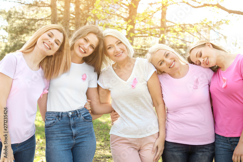 Beautiful women of different ages with pink ribbons outdoors. Breast cancer concept