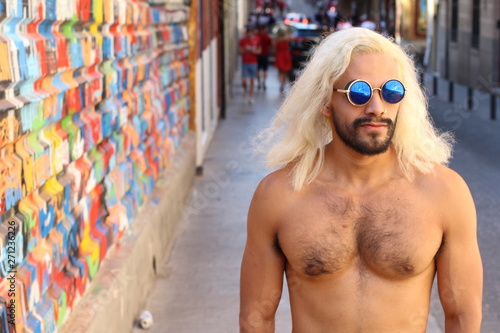 Shirtless man with blonde long dyed hair photo