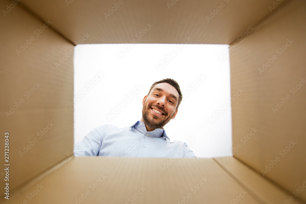 © Syda Productions - mail delivery and surprise concept - man looking into open parcel box, from below