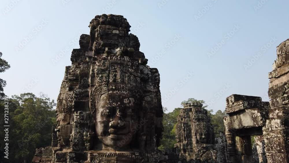 Huge stone faces on the towers of the ancient temple. Bayon. Angkor. Cambodia Huge stone faces on the towers of the ancient temple. Bayon. Angkor. Cambodia