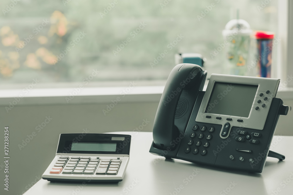 close up soft focus on ip phone devices and calculator at office desk, close up soft focus on ip phone devices and calculator at office desk,