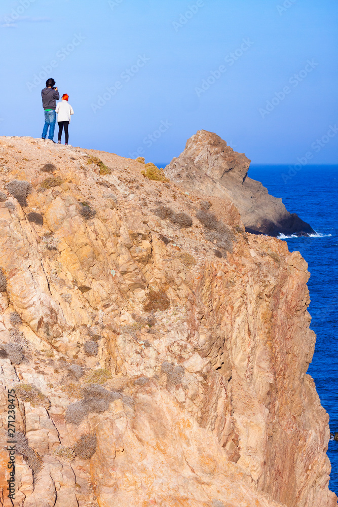 SEA LANDSCAPE WITH PEOPLE ON LARGE ROCKS ON THE SOUTHERN COAST OF SPAIN