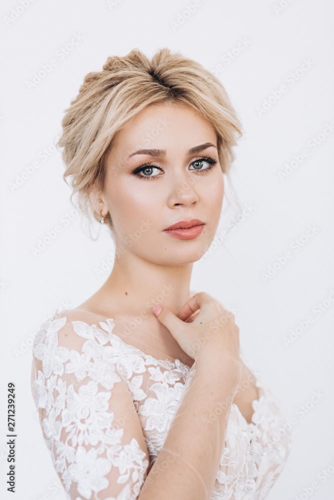 Studio portrait of a young girl of the bride with professional wedding makeup.