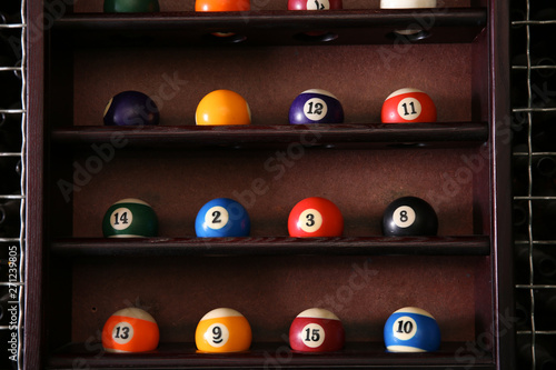 Wooden shelves with billiard balls