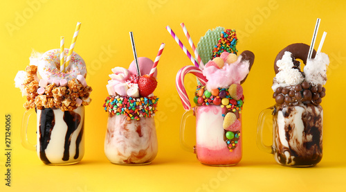 Canvas Print Different delicious freak shakes on color background