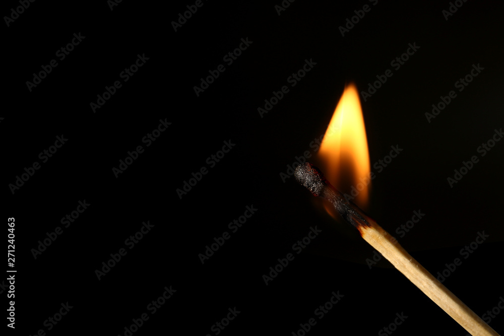 Burning match on black background Burning match on black background
