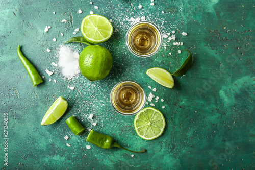 Fotografija Glasses of tasty tequila on color background