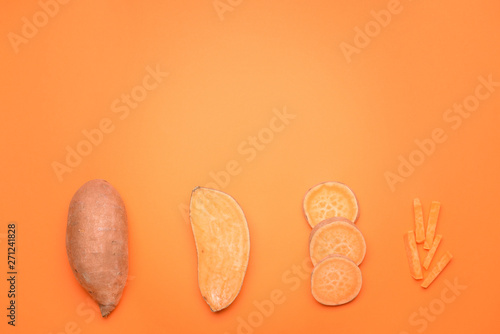 Fresh sweet potatoes on color background