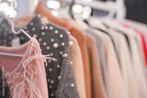 fashionable clothes hanging on hangers in the store. nobody.