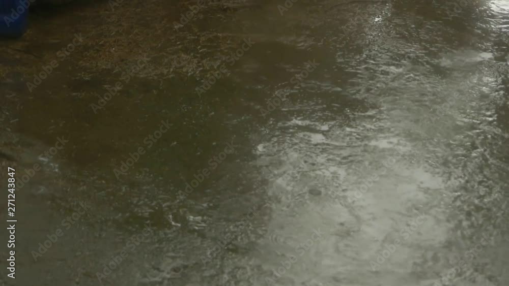 Streams of rain on the pavement Streams of rain on the pavement