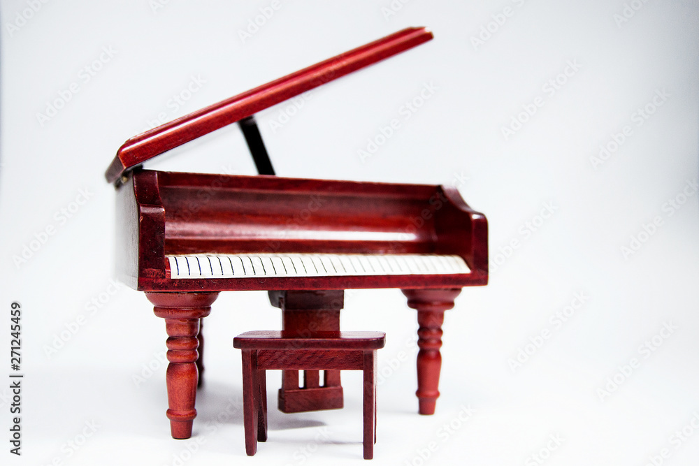 miniature classic piano keyboard instrument isolated on white background miniature classic piano keyboard instrument isolated on white background