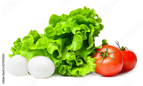 Vegetable composition from lettuce, eggs and tomatoes. White isolated background. Bright saturated colors. Close-up.
