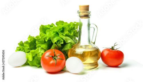 Salad, eggs, tomatoes and vegetable oil. White isolated background. Bright saturated colors.