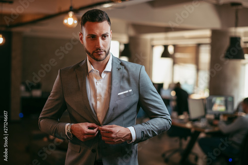 Portrait of attractive businessman in gray suit