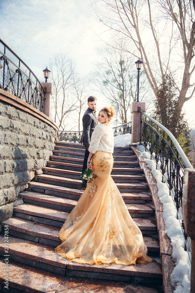 a walk of the newlyweds near an ancient castle, in a beautiful cream dress a walk of the newlyweds near an ancient castle, in a beautiful cream dress