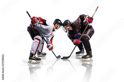 Hockey player isolated in white background starts game photo