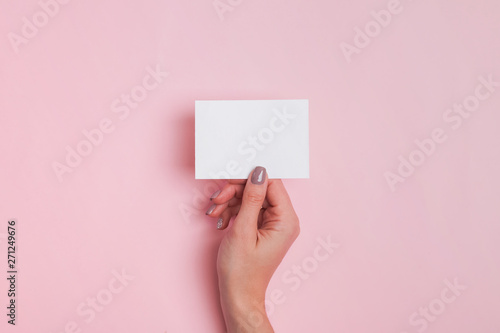 Woman's hand holding blank paper card
