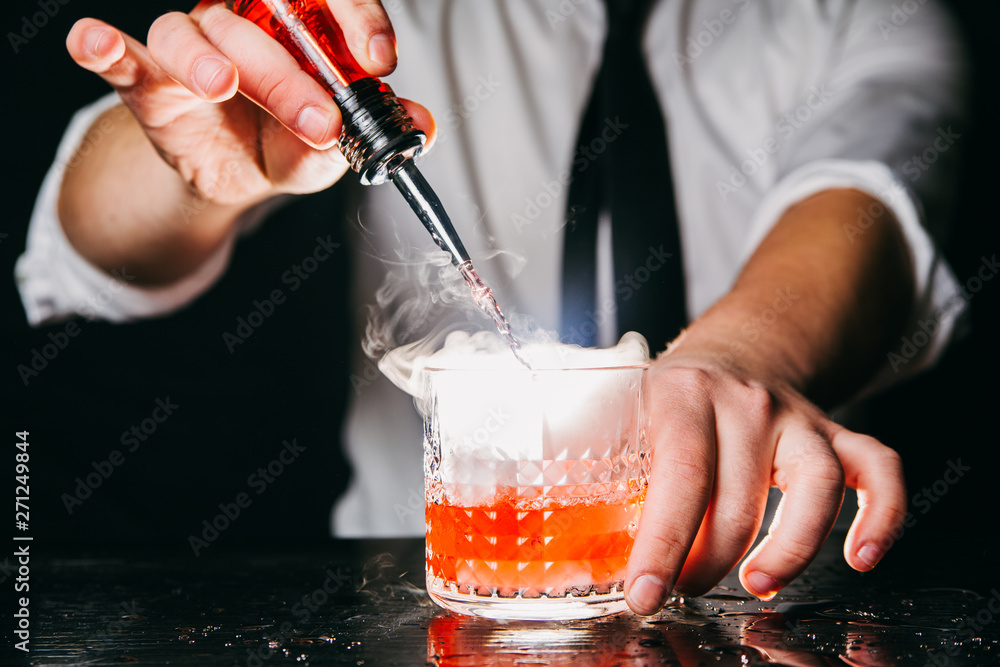 Barman making red smoking cocktail Barman making red smoking cocktail