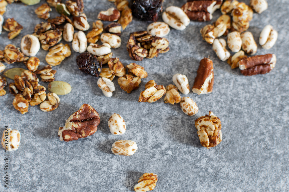 Organic homemade granola with pecan nuts on gray table, top view Organic homemade granola with pecan nuts on gray table, top view