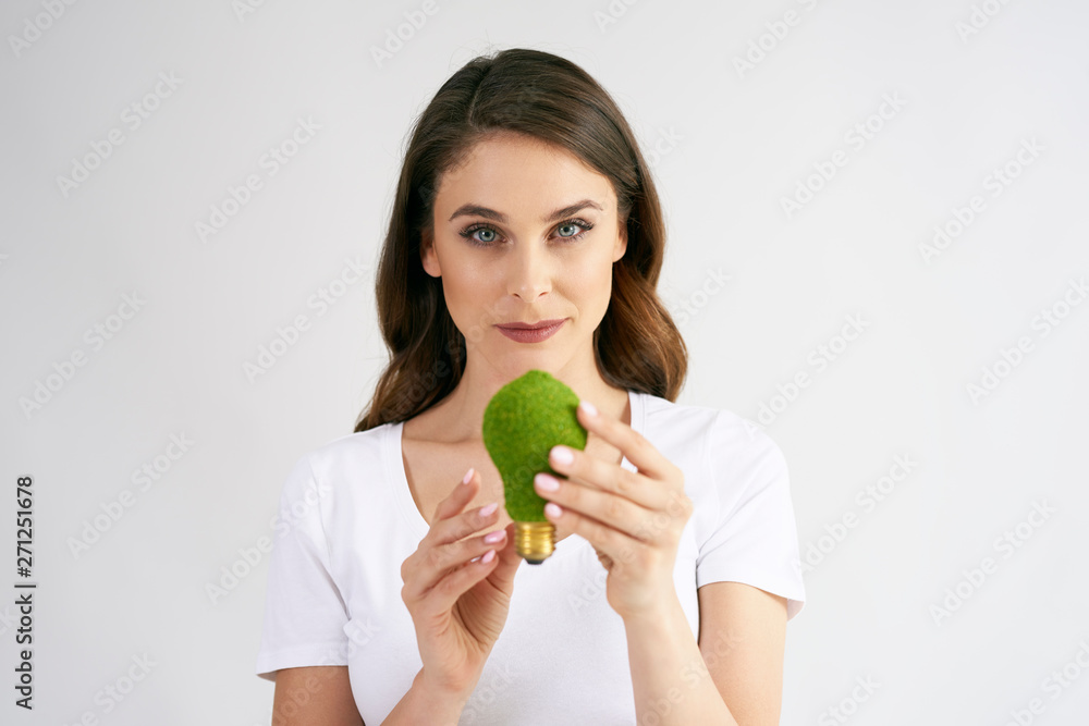 Woman holding a energy efficient light bulb Woman holding a energy efficient light bulb